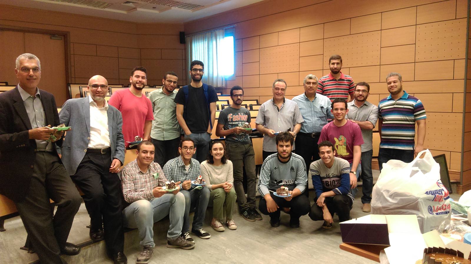 Ahmed Maarouf with physics students and colleagues at a lecture-hall celebration